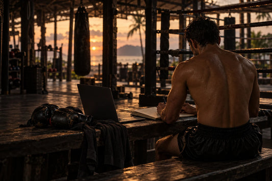 A fighter planning his business at a ringside desk after training